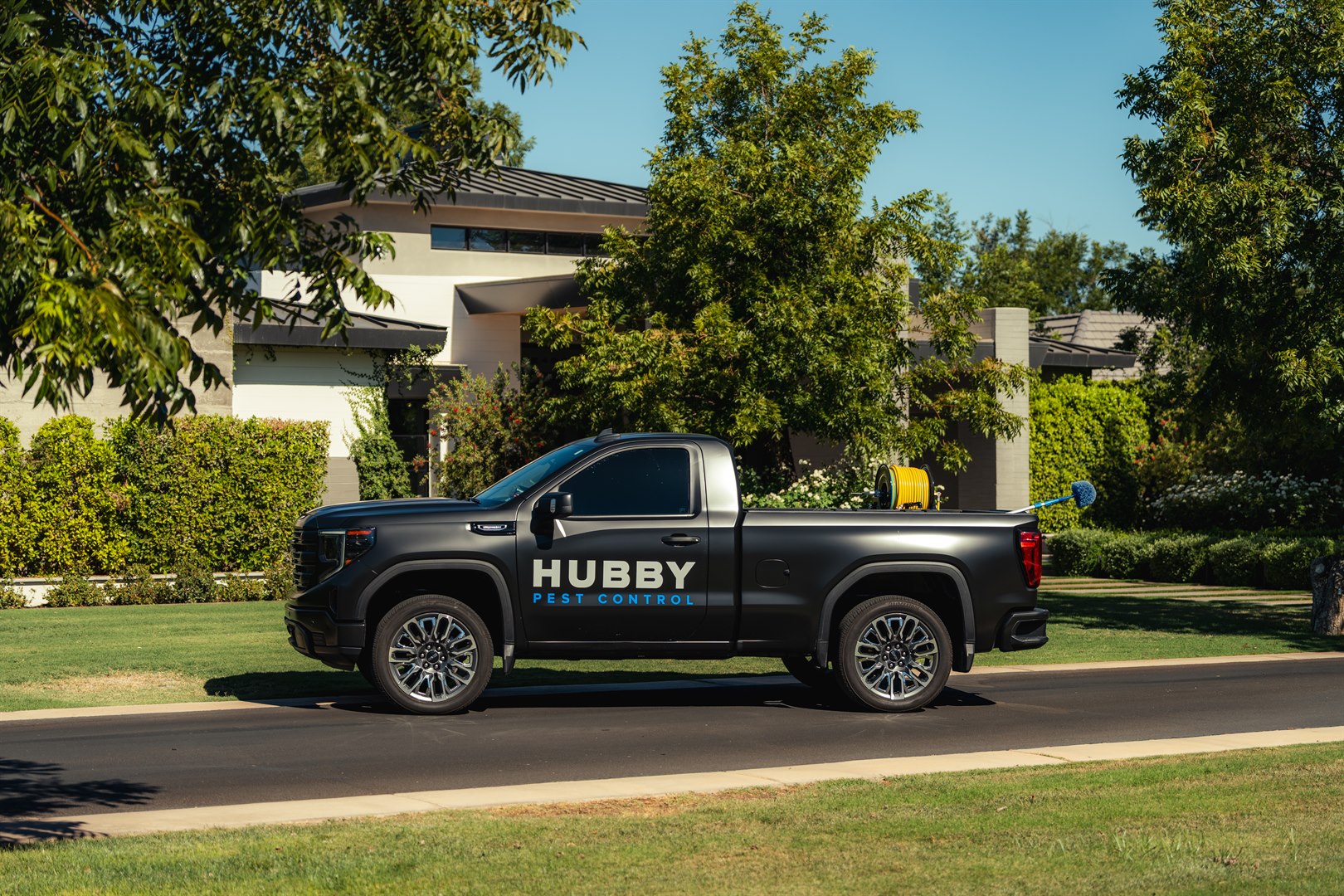 Hubby Pest Control truck in an East Valley neighborhood