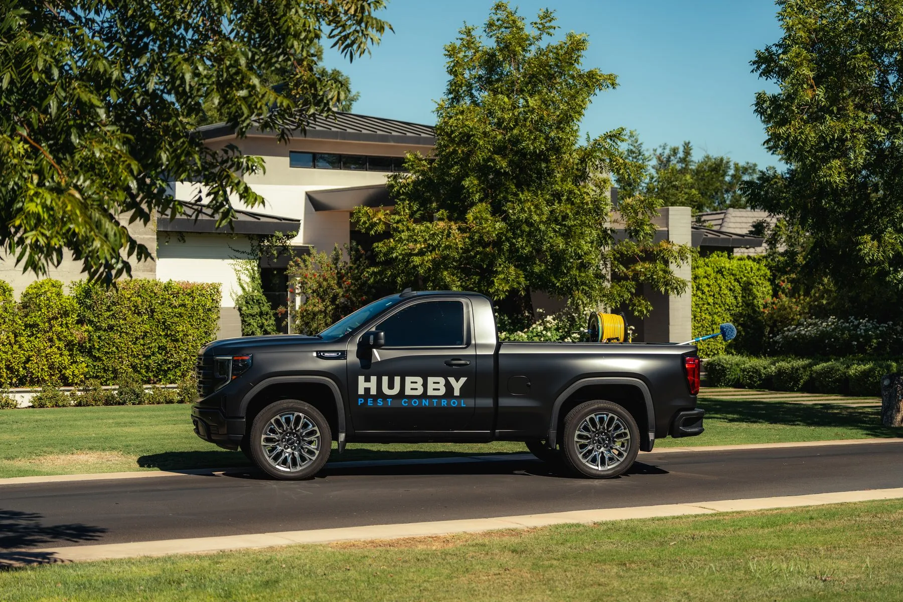 Hubby Pest Control truck in an East Valley neighborhood